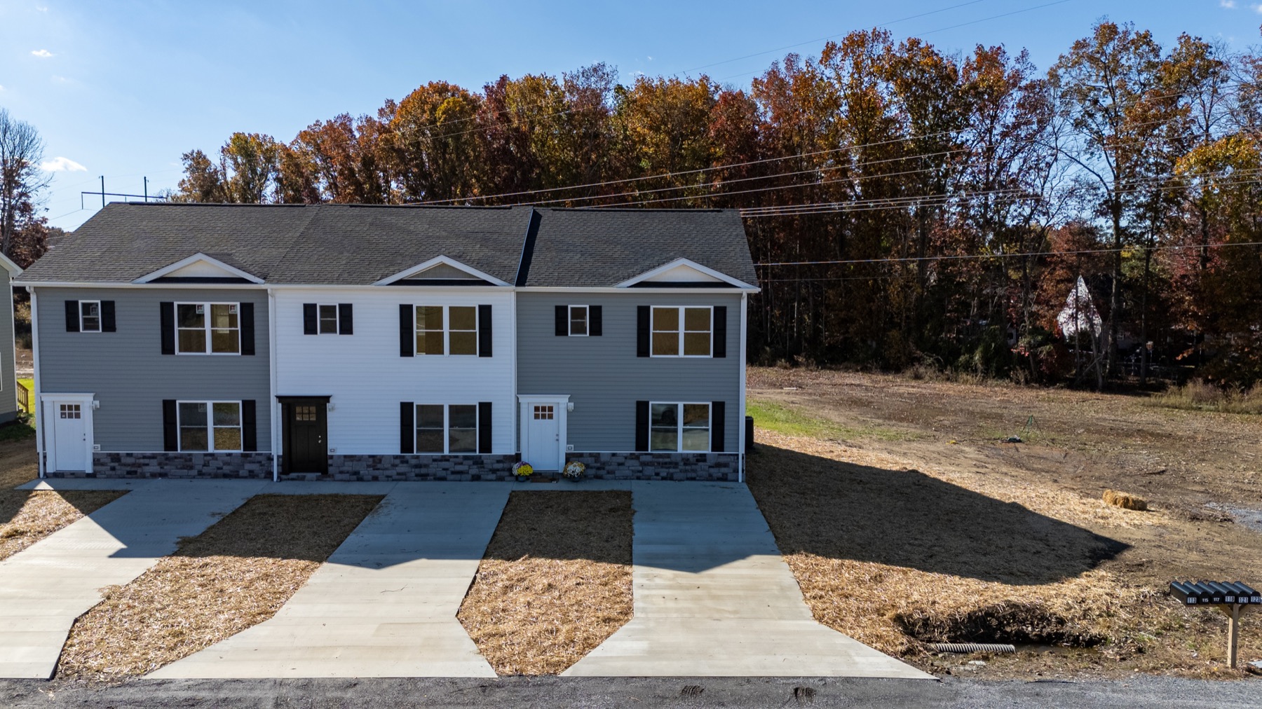 A row of completed Forest Station townhomes with individual driveways