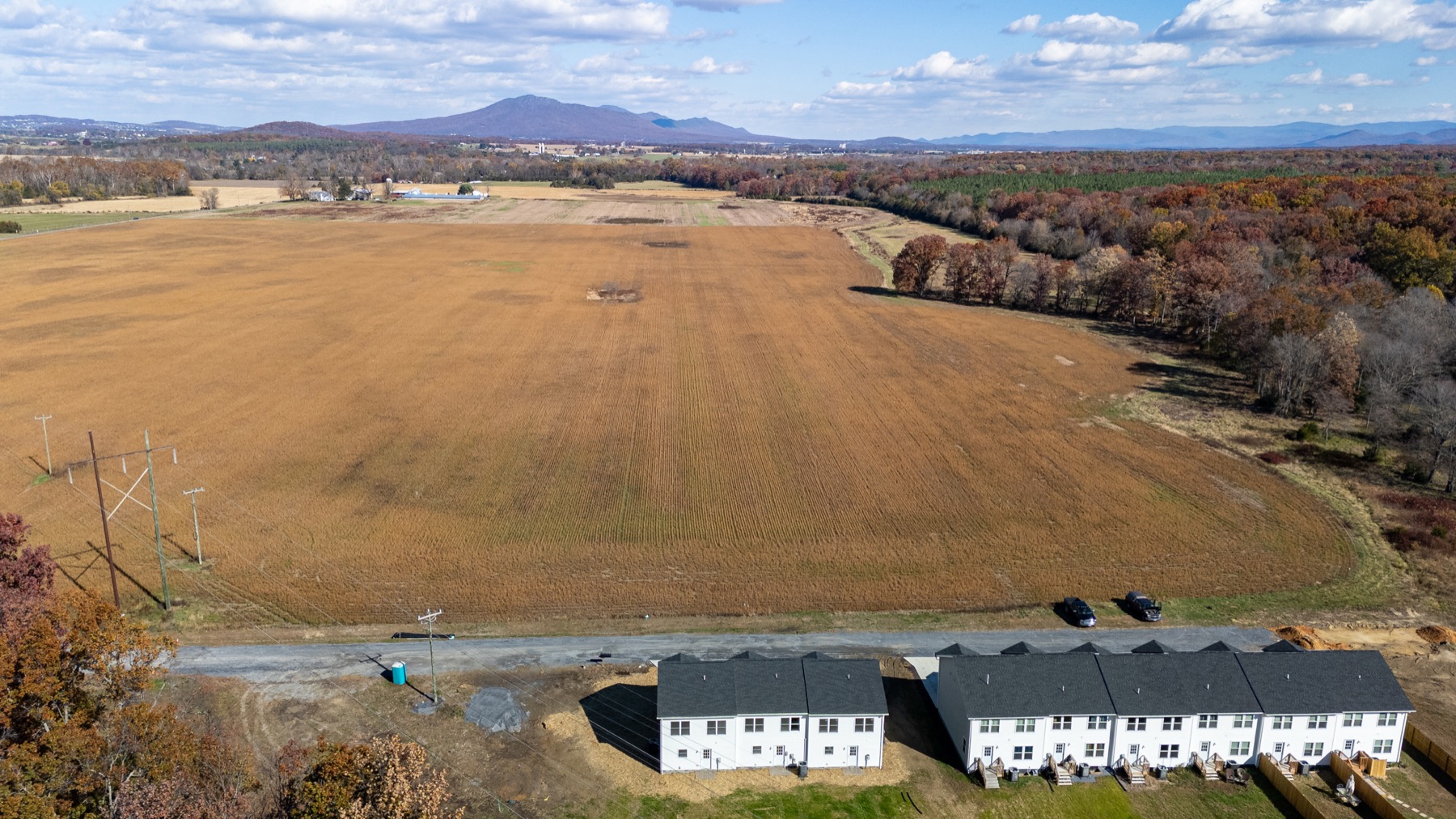 Aerial view of the farmland behind Forest Station with the Blue Ridge on the horizon